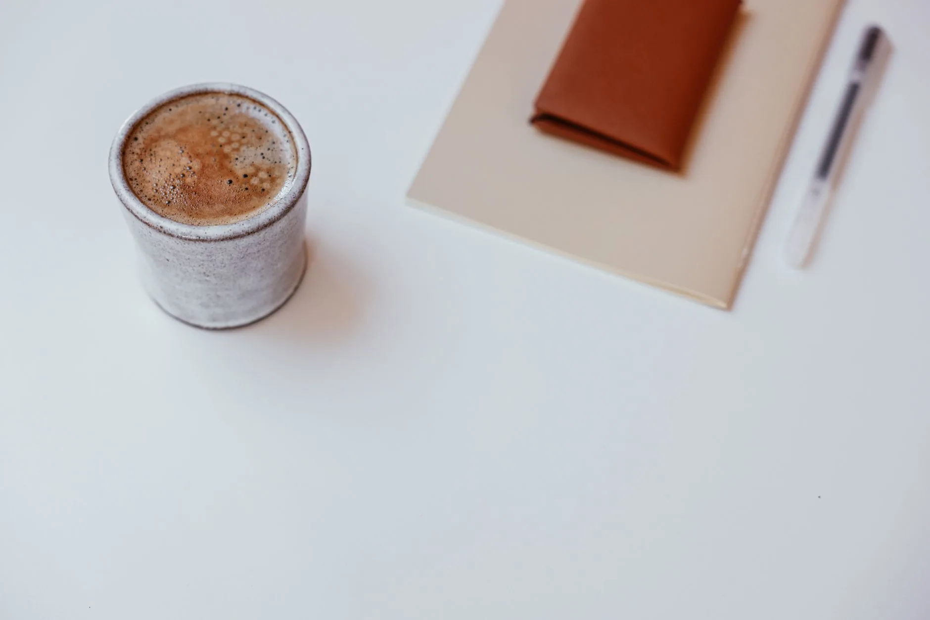 Leather notebook with dog-eared corner, soft lighting, muted colors, ordinal rules for essays.