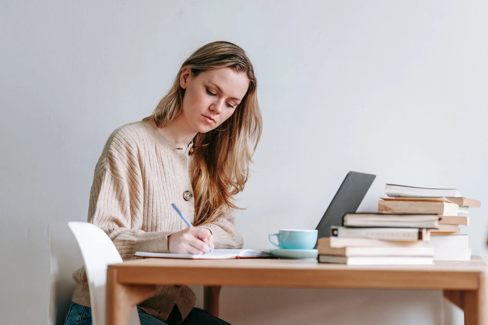 Writer at desk contemplates first-person, second-person, third-person perspectives for short story.