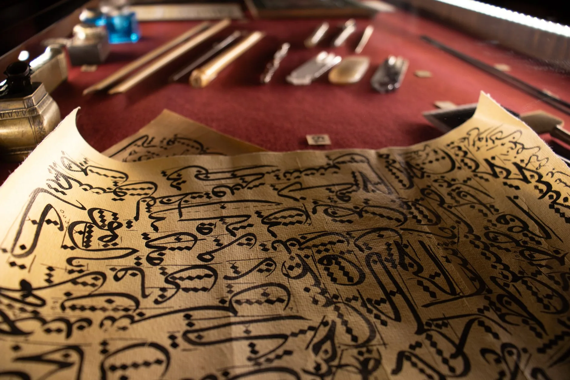 A writer at a worn wooden desk in soft, muted lighting, inclusive narration in personal essays.