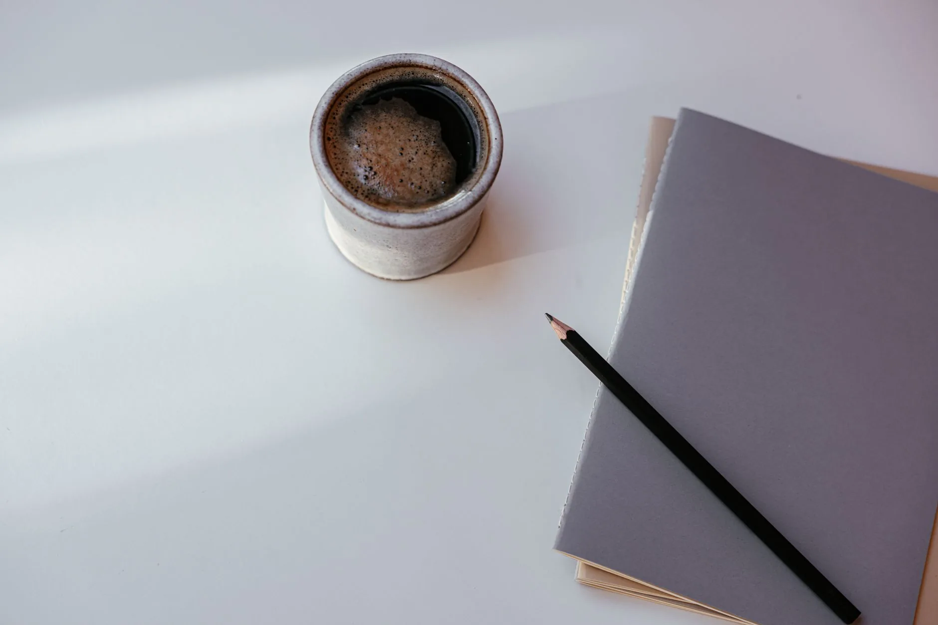 A cluttered desk with crumpled papers under soft, diffused light. Fanfics cross-pollinating with short stories.