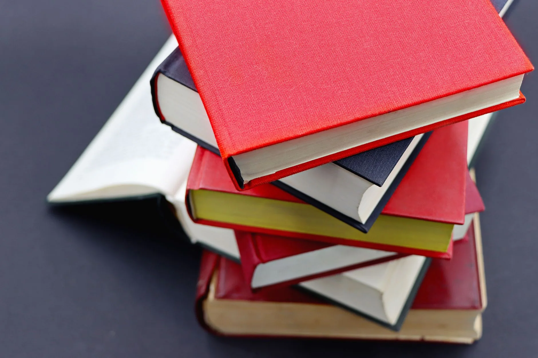 A cluttered desk with an open notebook, addressing the reader in fiction writing context.