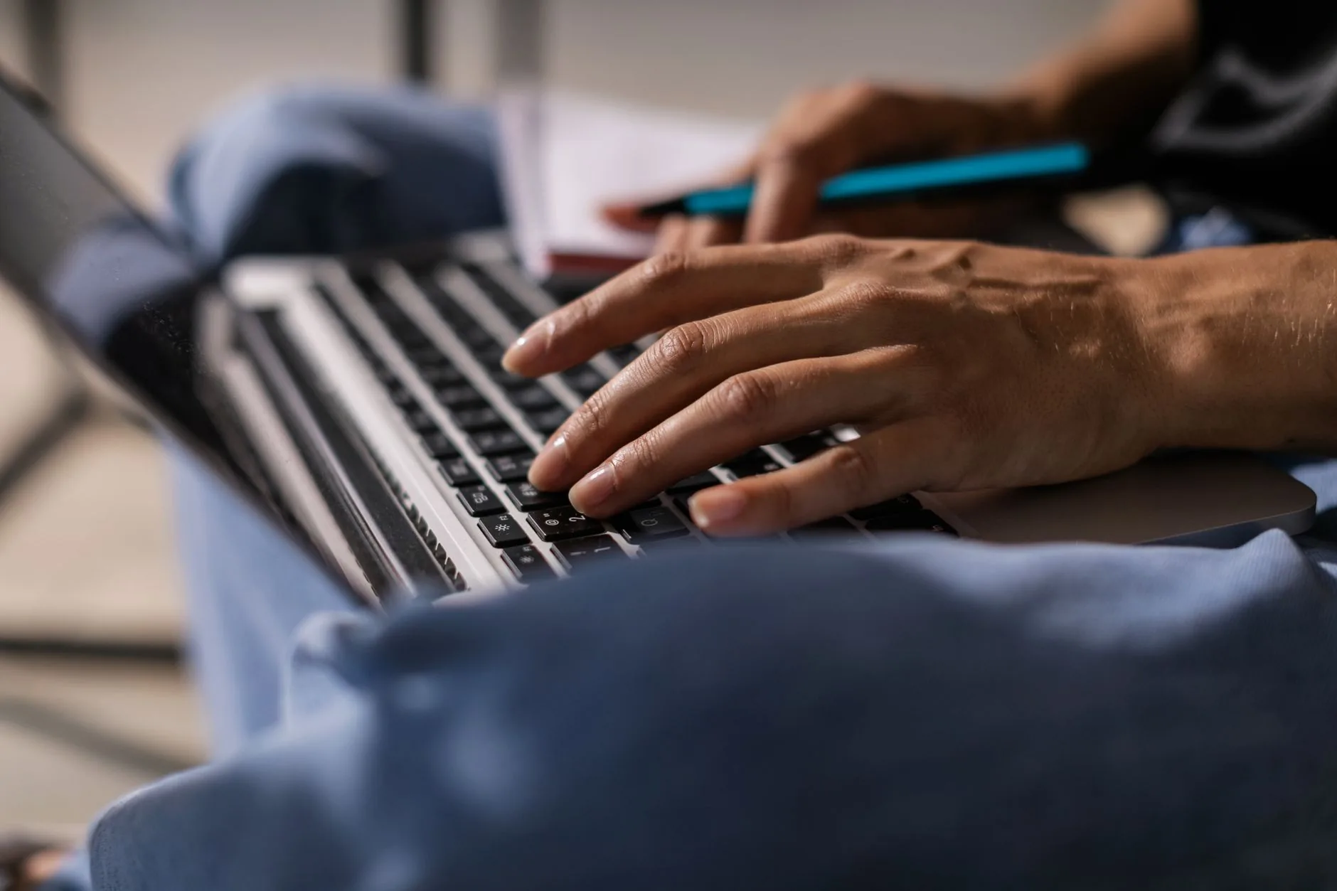 Writer at desk surrounded by papers, soft lighting, muted colors, wordplay techniques.